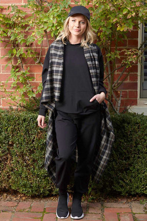 wool blend check cape with black hoodie and black jogger pants
