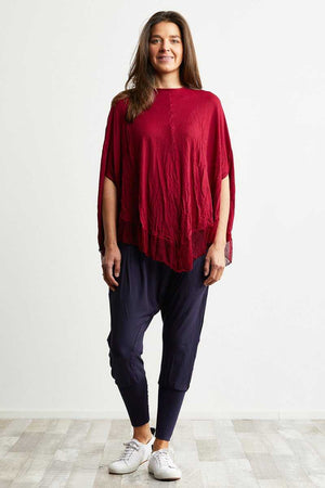 Pink poncho with mesh hem over dropped crotch viscose pant